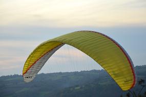 Colorful and beautiful parachute for paragliding, above the landscape