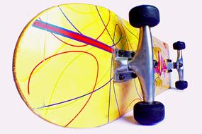 Close-up of the colorful, shiny skateboard with the lines and wheels