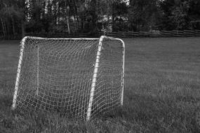 black and white photo of the goal on the football field