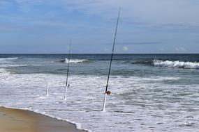 fishing rods in the surf on a sunny day