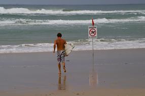 guy with surfboard on the beach in australia