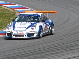 sports car racing on the track on a sunny day