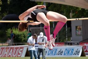 athlete jumping over the bar in athletics