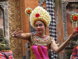 Woman, doing Barong Dance, in colorful and beautiful clothing, on Bali, Indonesia