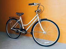 white bike parked near the building