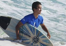 guy with surfboard in the ocean