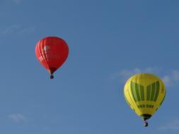red and yellow hot air balloons high in the sky
