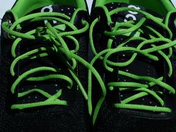 Beautiful, black shoes with bright, green shoelaces