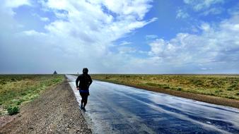 landscape of man on road water