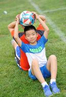 teenagers with a ball on the football field