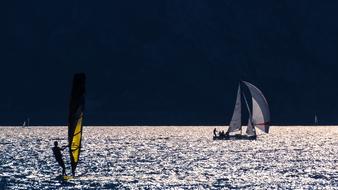 windsurfing on the water at dusk