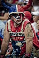 American football fan in blue, red and white clothing and paint, in Texas, America
