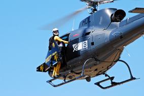 Person, jumping from the helicopter at blue sky, in New Zealand