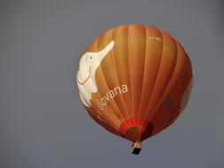 flying on orange hot air balloon close up