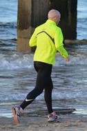 photo of a runner in a bright green jacket