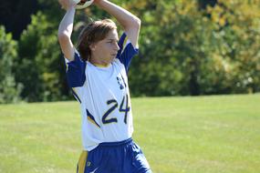 young football player throws the ball onto the field