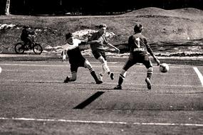 monochrome photo of a football game in the yard