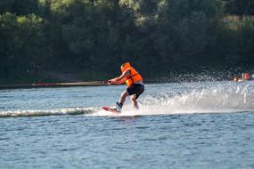 Wakeboarding, man speeding on Lake