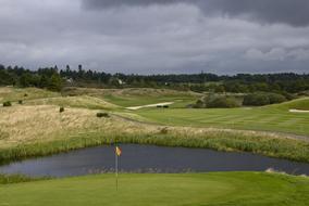 panoramic view of a golf course in scotland on a cloudy day