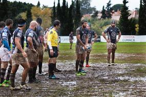 men on the field in the mud