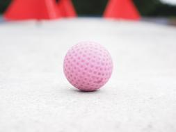 Close-up of the beautiful, pink mini golf ball in light