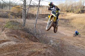 jumping motorcycle cross country on a cloudy day