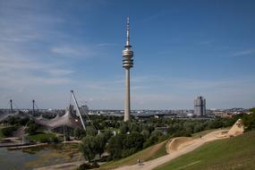 Landscape of the Olympic Site with green plants, in Munich, Bavaria, Germany, under the blue sky with clouds