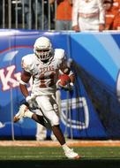 American football athlete running with the ball