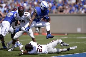 fighting for the ball while playing American football