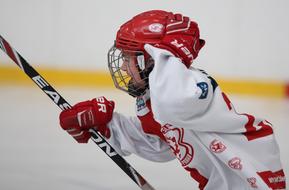 hockey player with a hockey stick while playing on the rink