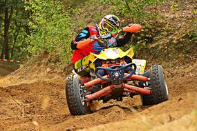 an athlete on a quad bike on a rough road