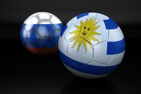 soccer balls with russia and uruguay flags