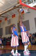 Harlem Globetrotters in colorful uniform, playing on the court, on the competition