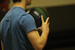 Bowling Ball in hands on a blurred background