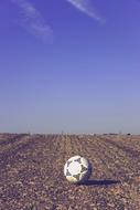 soccer ball on plowed field