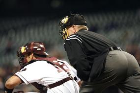 Baseball umpire and catcher on the field, on the competition
