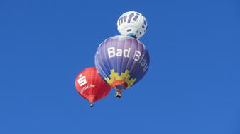 three hot air balloons in the blue sky