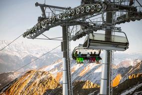 ski lift with tourists over the mountain