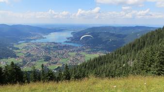 Beautiful landscape of Tegernsee and paraglider, near the water, among the colorful mountains, in Germany
