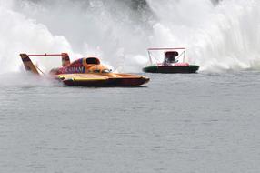 Colorful hydro racing boats on the water with ripple
