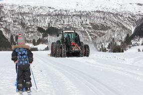 tractor on the ski track near the mountain