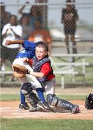 Kid players on the Little League game of baseball, outdoors