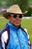 man wearing wide Hat, Sunglasses and Club clothing