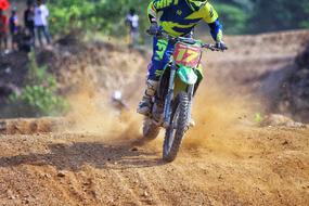 motorcyclist rides on a sandy road during a race
