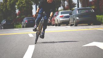 cyclist on the median strip on the road