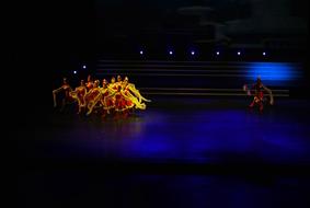 Dancers Performance on a dark stage