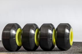 Close-up of the shiny, black and yellow skateboard wheels