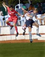 wrestling for the ball in women's football during a game