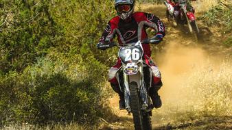 motorcyclists on a sandy track during races