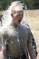 Man in t-shirt, cooling in water, in sunlight, outdoors